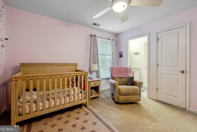 bedroom with ceiling fan, carpet flooring, and a nursery area