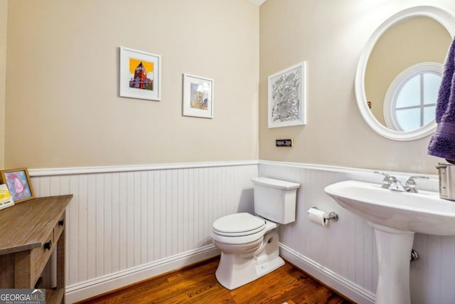 bathroom with toilet, sink, and hardwood / wood-style flooring