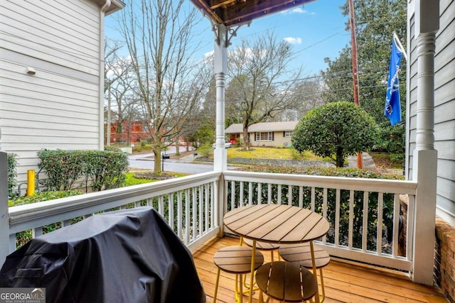 wooden deck featuring a grill