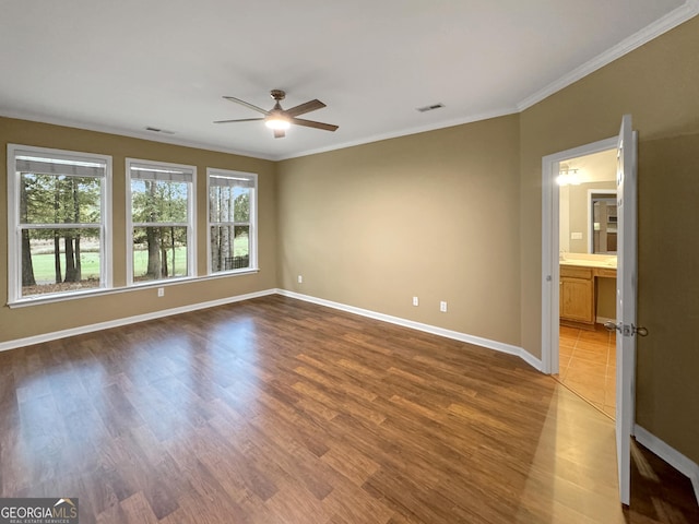 unfurnished room featuring hardwood / wood-style flooring, ceiling fan, and ornamental molding