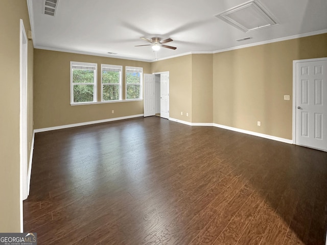 spare room featuring crown molding, ceiling fan, and dark wood-type flooring