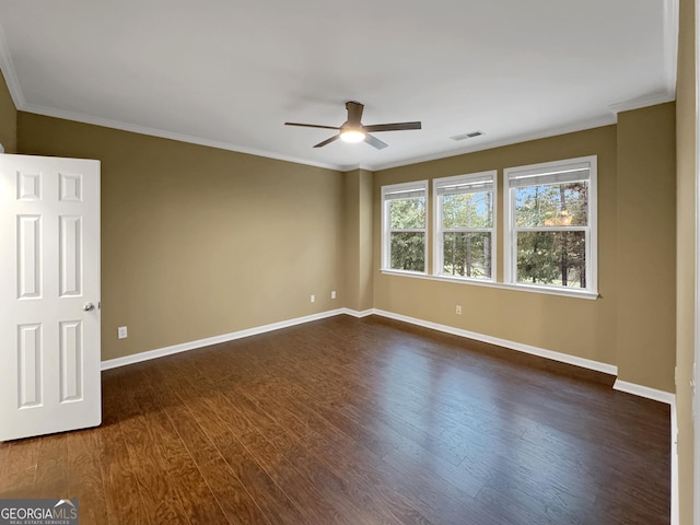 spare room with ceiling fan, crown molding, and dark wood-type flooring