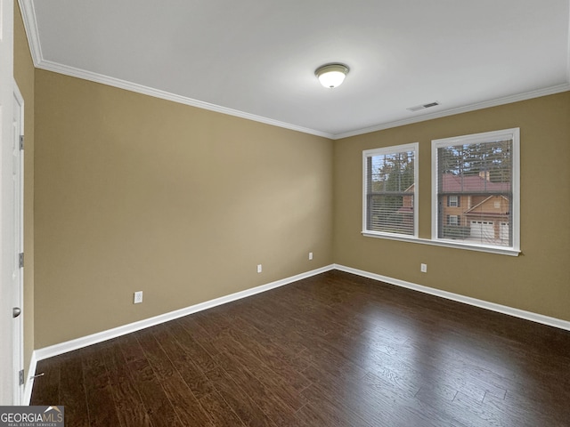 spare room with dark hardwood / wood-style flooring and crown molding