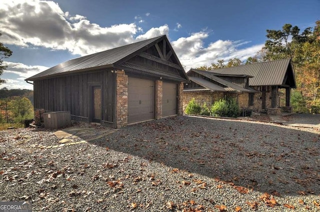 view of home's exterior with a garage and an outdoor structure