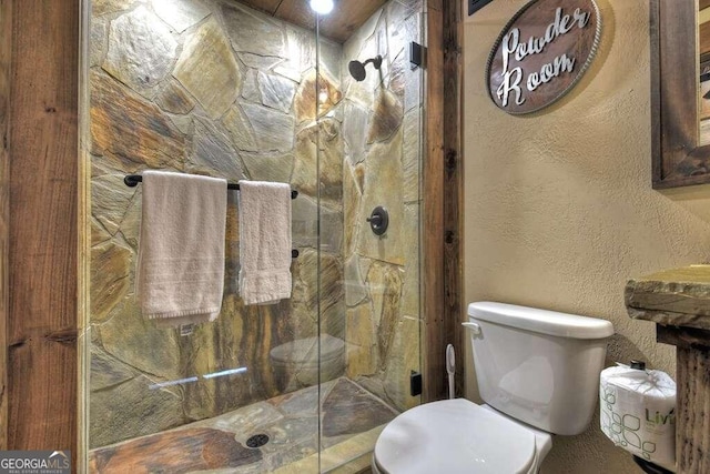 bathroom featuring walk in shower and toilet