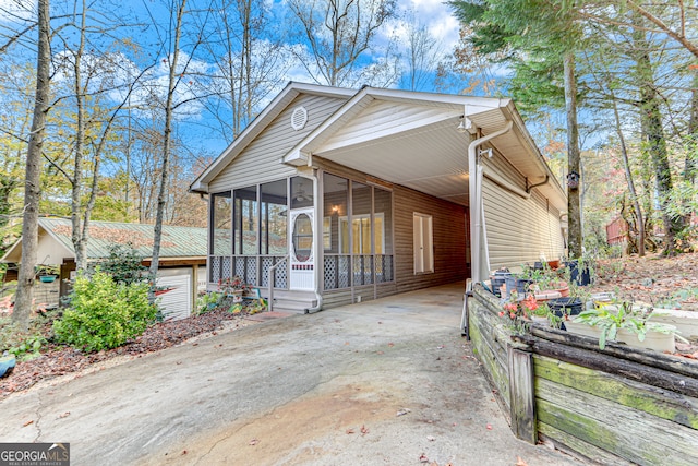 view of front of house with a sunroom and a carport