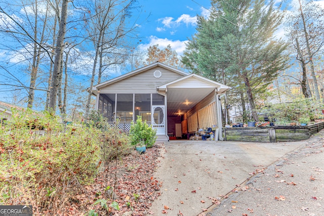 view of front of property featuring a sunroom and a carport