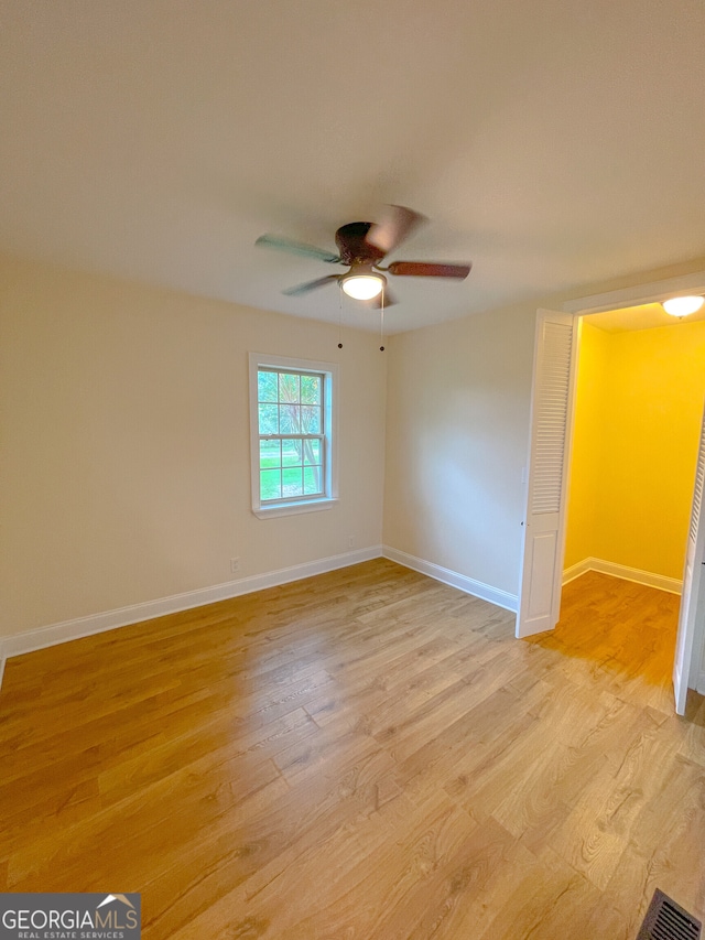 empty room with light hardwood / wood-style floors and ceiling fan