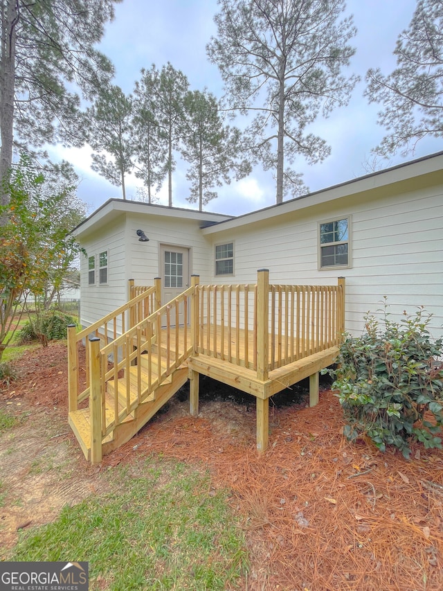 back of property featuring a wooden deck