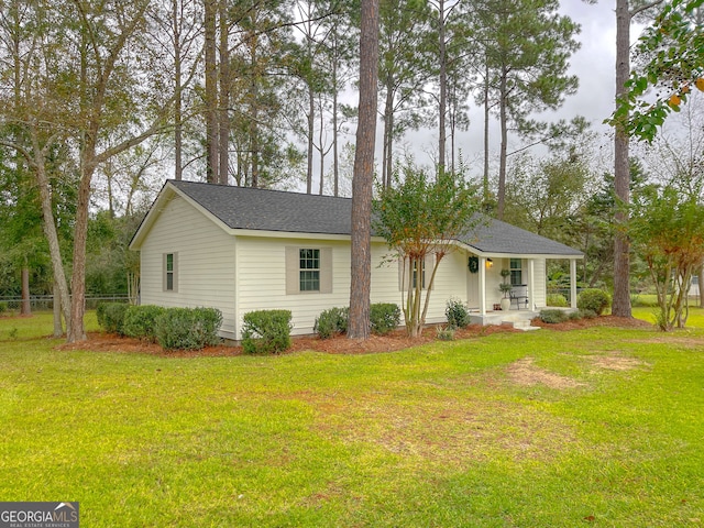 view of front of house with a front yard and a porch