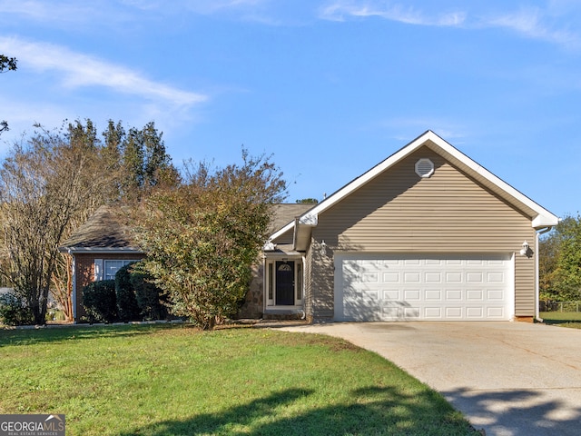 view of front of home with a front yard and a garage