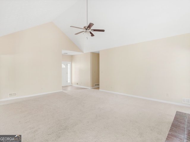 unfurnished living room featuring light carpet, high vaulted ceiling, and ceiling fan