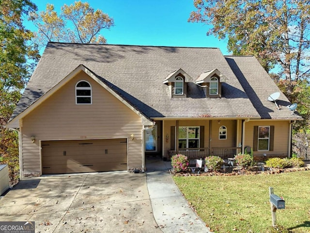 view of front facade featuring a garage, a porch, and a front lawn