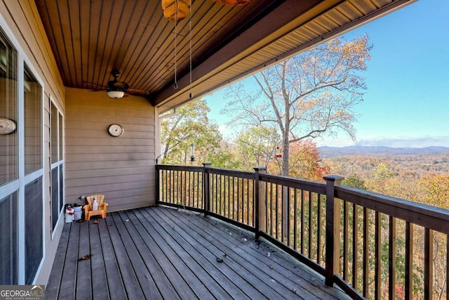 deck with a mountain view and ceiling fan