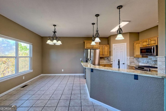 kitchen featuring tasteful backsplash, light tile patterned flooring, light stone countertops, appliances with stainless steel finishes, and decorative light fixtures