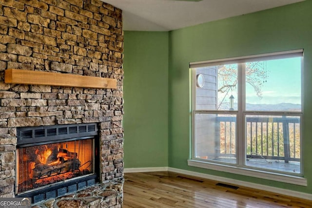 living room with hardwood / wood-style floors and a fireplace