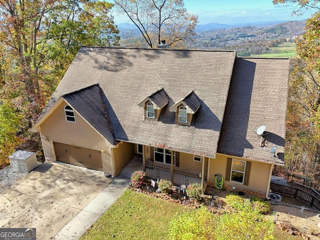 view of front facade featuring a mountain view, a garage, and covered porch