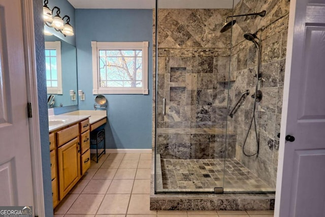 bathroom with vanity, tile patterned floors, and a tile shower