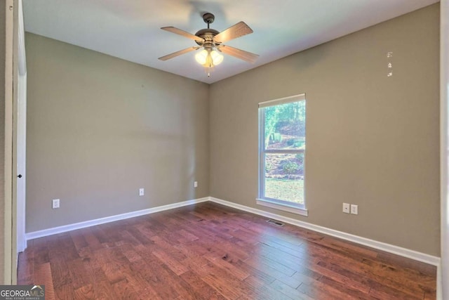 spare room featuring ceiling fan and dark hardwood / wood-style floors