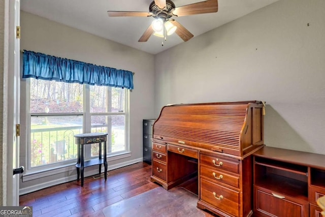 home office with dark wood-type flooring and ceiling fan