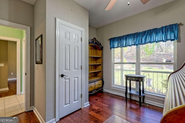 interior space with ceiling fan and dark hardwood / wood-style floors