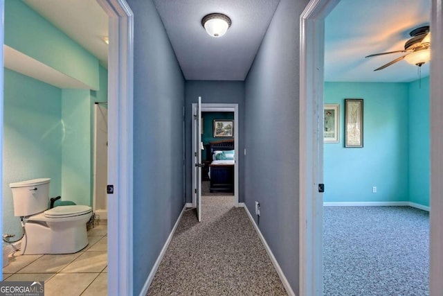 hall with light colored carpet