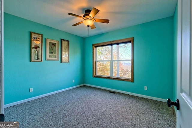 spare room featuring carpet flooring and ceiling fan