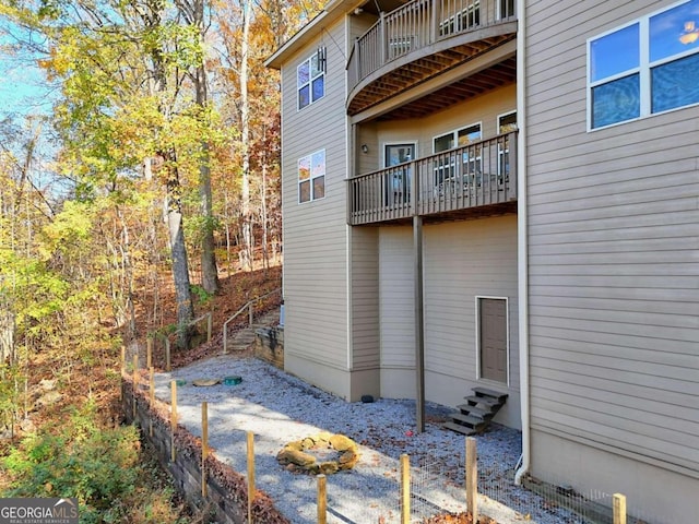 view of side of property with a balcony