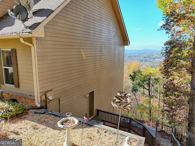 view of side of home with a mountain view