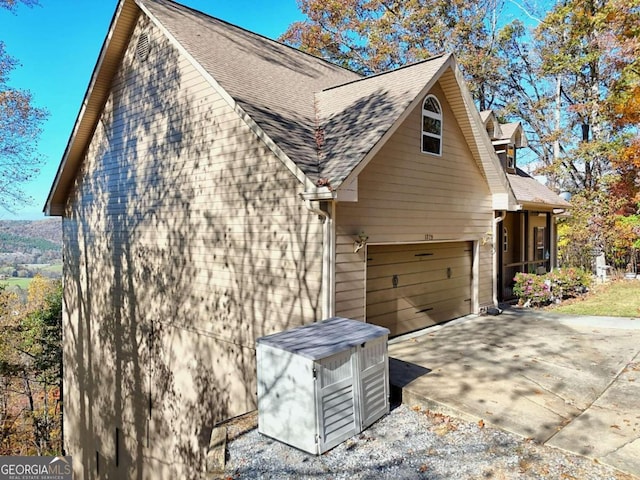 view of side of home featuring a garage