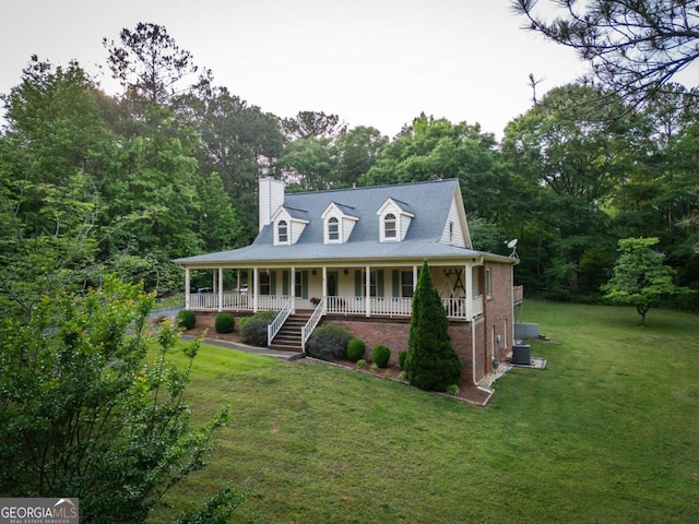 view of front of property with central air condition unit, a porch, and a front yard