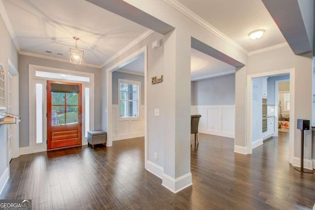 entryway with dark hardwood / wood-style flooring and crown molding