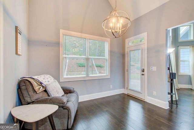 sitting room with high vaulted ceiling, a notable chandelier, and dark hardwood / wood-style floors