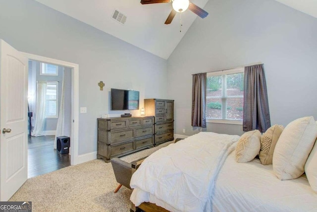 carpeted bedroom with high vaulted ceiling and ceiling fan