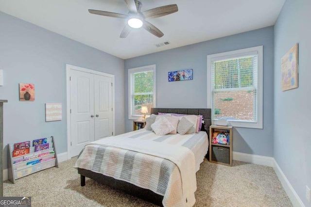 carpeted bedroom featuring a closet and ceiling fan