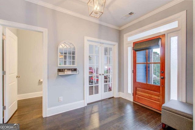 entrance foyer featuring dark hardwood / wood-style flooring, french doors, and ornamental molding