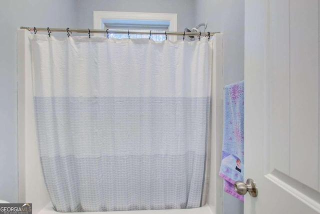 bathroom featuring shower / bathtub combination with curtain