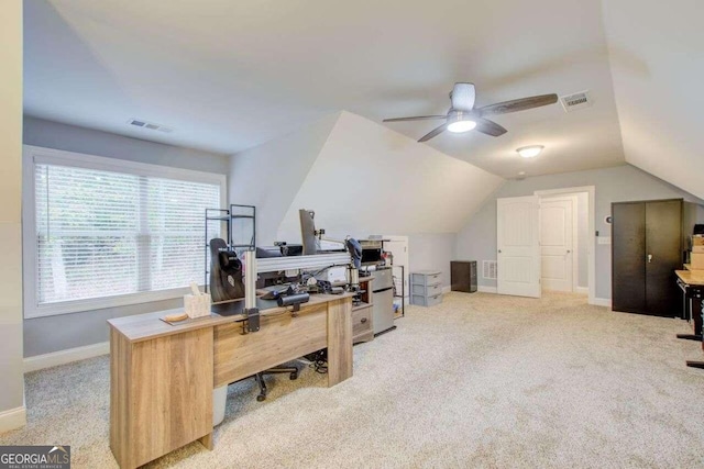 carpeted home office with lofted ceiling and ceiling fan