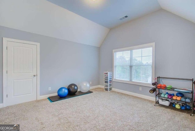 workout room featuring carpet flooring and vaulted ceiling