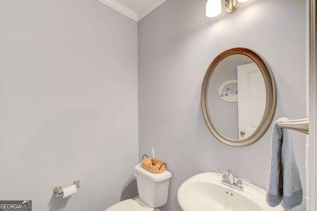 bathroom featuring ornamental molding, sink, and toilet