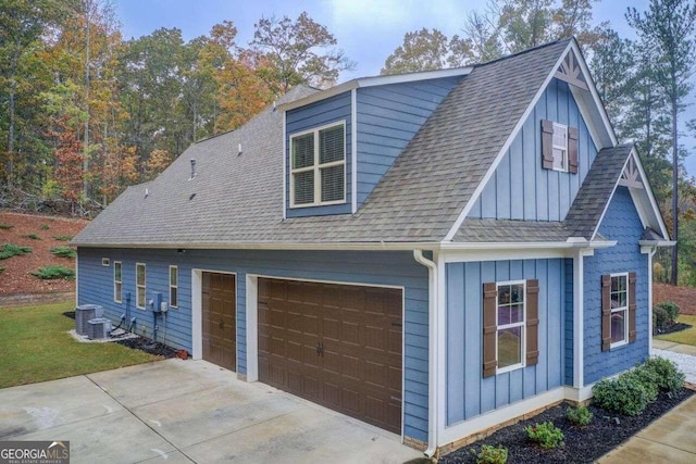 view of side of home featuring central air condition unit and a garage