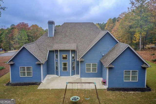 back of property featuring a lawn and a patio