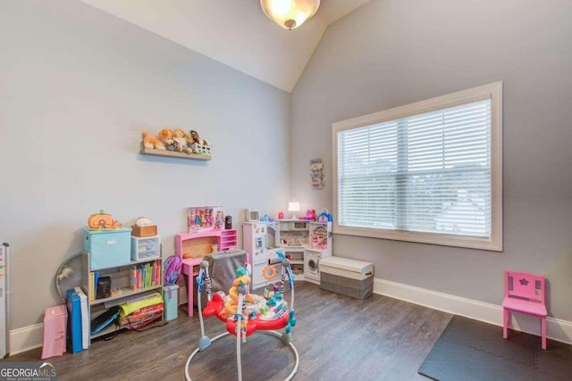 playroom with vaulted ceiling and dark hardwood / wood-style flooring