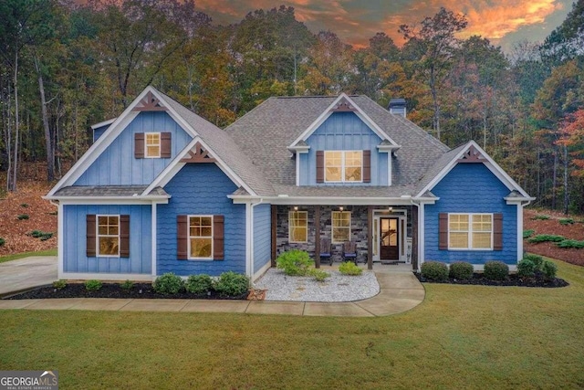 craftsman-style home with a porch and a yard