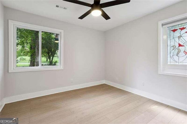 empty room with light hardwood / wood-style floors and ceiling fan