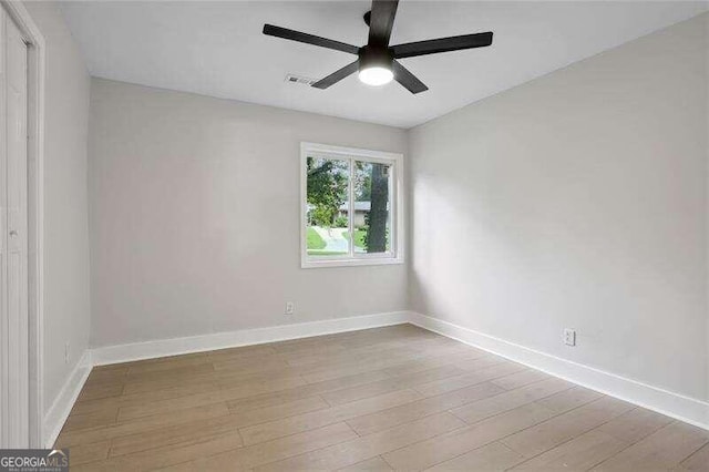 empty room featuring ceiling fan and light hardwood / wood-style flooring