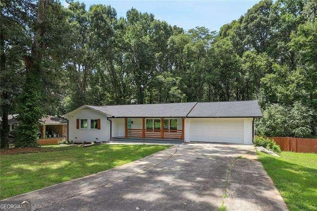 ranch-style home with a garage and a front lawn