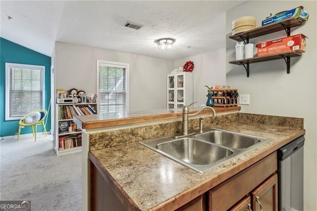 kitchen with light colored carpet, lofted ceiling, dishwasher, a textured ceiling, and sink