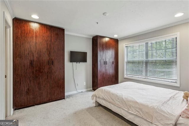 bedroom with light carpet and crown molding