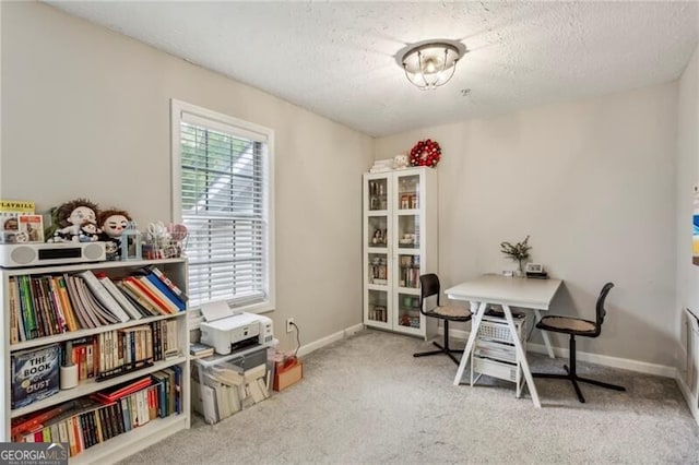 home office featuring a textured ceiling and light carpet